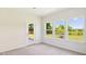 Neutral bedroom with view of the backyard and an outdoor door at 217 Walker Grv Ln, Lillington, NC 27546