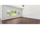 Bright bedroom boasts hardwood floors and large windows offering a view of lush greenery at 217 Walker Grv Ln, Lillington, NC 27546