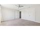 Large bedroom with plush carpet, ceiling fan, and large closet with double doors at 217 Walker Grv Ln, Lillington, NC 27546