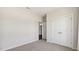 Simple bedroom featuring plush carpet, double door closet, ceiling fan, and access to another room at 217 Walker Grv Ln, Lillington, NC 27546