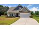 Charming home with a two-car garage, well-maintained lawn, and appealing curb appeal at 217 Walker Grv Ln, Lillington, NC 27546