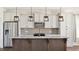 Well-designed kitchen with a granite island, custom pendant lights, and stainless steel appliances at 217 Walker Grv Ln, Lillington, NC 27546
