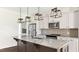 Modern kitchen features a granite island, pendant lights, and stainless steel appliances at 217 Walker Grv Ln, Lillington, NC 27546