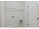 The laundry room features tile flooring, wire shelving, and utility connections at 217 Walker Grv Ln, Lillington, NC 27546