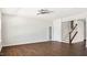 Open living room features hardwood floors, a ceiling fan, and a staircase to the upper level at 217 Walker Grv Ln, Lillington, NC 27546