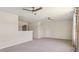 Open living room with two ceiling fans, plush carpet, and a window with decorative patterned curtains at 217 Walker Grv Ln, Lillington, NC 27546