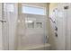 Modern bathroom featuring tiled walk-in shower with a glass door, shower seat, and transom window at 217 Walker Grv Ln, Lillington, NC 27546