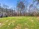 Lush backyard featuring mature trees and partial views of the home at 2309 Laurelford Ln, Wake Forest, NC 27587