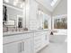Elegant bathroom with double vanity, soaking tub, and modern fixtures at 2309 Laurelford Ln, Wake Forest, NC 27587