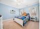 Bright bedroom featuring a white bed frame, carpeted floor and cozy decor with a teddy bear at 2309 Laurelford Ln, Wake Forest, NC 27587