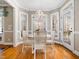 Bright breakfast nook with white table and chairs, hardwood floors, and natural light at 2309 Laurelford Ln, Wake Forest, NC 27587