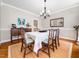 Comfortable dining room featuring a buffet, hardwood floors and a large mirror at 2309 Laurelford Ln, Wake Forest, NC 27587