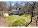 Aerial backyard view of a two story home, tree swing, shed, and blue skies at 2309 Laurelford Ln, Wake Forest, NC 27587