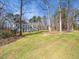 Lovely two-story home with a well-manicured lawn surrounded by mature trees at 2309 Laurelford Ln, Wake Forest, NC 27587