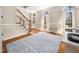 Inviting foyer featuring hardwood floors, staircase, and ample natural light from large windows at 2309 Laurelford Ln, Wake Forest, NC 27587