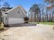 Attached garage with a basketball hoop, driveway, and side-entry at 2309 Laurelford Ln, Wake Forest, NC 27587