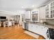 Open kitchen featuring white cabinets, granite counters, stainless appliances, and hardwood flooring at 2309 Laurelford Ln, Wake Forest, NC 27587