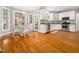 Well-lit kitchen featuring white cabinetry, modern appliances, hardwood floors, and a breakfast nook at 2309 Laurelford Ln, Wake Forest, NC 27587