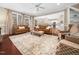 Open concept living room with hardwood floors, comfortable seating, and abundant natural light at 2309 Laurelford Ln, Wake Forest, NC 27587