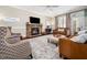 Living room features a cozy fireplace, leather furniture, and elegant decor at 2309 Laurelford Ln, Wake Forest, NC 27587