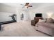 Cozy living room with comfortable seating, a treadmill and carpeted floors at 2309 Laurelford Ln, Wake Forest, NC 27587