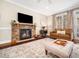 Cozy living room with stone fireplace, leather sofa, and decorative rug at 2309 Laurelford Ln, Wake Forest, NC 27587