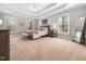 Spacious main bedroom with ample natural light, plush carpet, and stylish decor at 2309 Laurelford Ln, Wake Forest, NC 27587