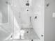 Sleek, modern shower with glass enclosure, rainfall showerhead, and tiled floor at 2309 Laurelford Ln, Wake Forest, NC 27587