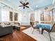 Inviting sunroom with a cozy seating area, wood floors and ample natural light at 2309 Laurelford Ln, Wake Forest, NC 27587