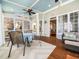 Bright sunroom with wood floors and ample natural light, perfect for relaxation at 2309 Laurelford Ln, Wake Forest, NC 27587