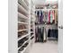 Organized walk-in closet featuring built-in shelving and ample storage space for clothes and shoes at 2309 Laurelford Ln, Wake Forest, NC 27587