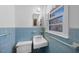 A blue tiled bathroom with a unique sink and toilet at 2311 Glover Rd, Durham, NC 27703