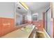 A bathroom with pink tile, a yellow sink, and a shower with glass doors at 2311 Glover Rd, Durham, NC 27703