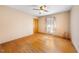 A simple bedroom with hardwood floors, a ceiling fan, and a window at 2311 Glover Rd, Durham, NC 27703
