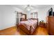 A bright bedroom with a wooden bed, matching dressers, and hardwood floors at 2311 Glover Rd, Durham, NC 27703