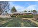 Exterior view of brick home with mature shrubbery and nice grass at 2311 Glover Rd, Durham, NC 27703
