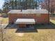 Rear exterior view of a brick two-story home at 2311 Glover Rd, Durham, NC 27703