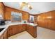 Traditional kitchen with wooden cabinets, white countertops, and adjacent dining nook at 2311 Glover Rd, Durham, NC 27703