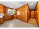 Bright eat-in kitchen featuring wood paneling and neutral flooring at 2311 Glover Rd, Durham, NC 27703