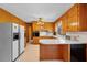 Functional kitchen with wood cabinets, white countertops, and updated appliances at 2311 Glover Rd, Durham, NC 27703