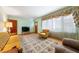 Cozy living room featuring a large window, patterned rug, and comfortable seating, creating a warm and inviting atmosphere at 2311 Glover Rd, Durham, NC 27703
