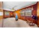 A wood-paneled living room with a ceiling fan and two rocking chairs at 2311 Glover Rd, Durham, NC 27703
