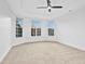 Spacious bedroom with neutral carpeting, tray ceiling, ceiling fan, and lots of natural light at 2505 Mt Zion Church Rd Rd, Apex, NC 27502