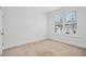 Bright bedroom with neutral carpeting and a large window with shutter style blinds at 2505 Mt Zion Church Rd Rd, Apex, NC 27502