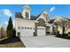 Exterior home featuring a two-car garage, stone accents, and manicured landscaping at 2505 Mt Zion Church Rd Rd, Apex, NC 27502