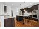 Gourmet kitchen features granite countertops, dark cabinetry, stainless steel appliances, and hardwood floors at 2505 Mt Zion Church Rd Rd, Apex, NC 27502