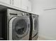 Well-equipped laundry room with front-loading washer and dryer, plus ample storage space at 2505 Mt Zion Church Rd Rd, Apex, NC 27502