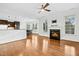 Open concept living room features a fireplace, hardwood floors, and modern lighting at 2505 Mt Zion Church Rd Rd, Apex, NC 27502