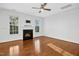 An open-concept living room featuring a fireplace, hardwood floors, and large windows at 2505 Mt Zion Church Rd Rd, Apex, NC 27502