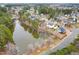 An aerial view displays a waterfront community with stunning homes located near a lake, surrounded by verdant trees and foliage at 2639 Bowden Dr, Creedmoor, NC 27522